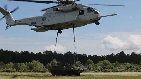 U.S. Marines CH-53K King Stallion helicopter lowering Light Armored Vehicle Stock Footage 285396704