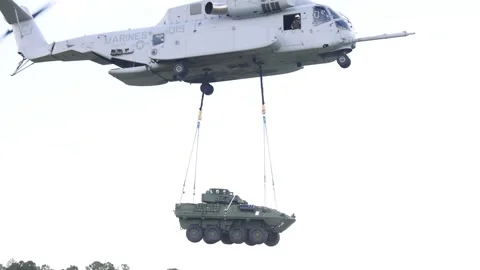 U.S. Marines CH-53K King Stallion external lift with Light Armored Vehicle Stock Footage 285396748
