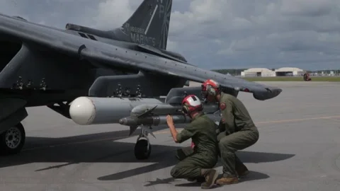 U.S. Marines check AV-8B Harrier II ordnance and removes 'Remove before flight'  Stock Footage 210136656