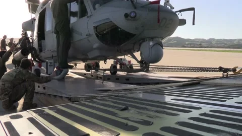 U.S. Marines checking ground clearance during loading of UH-1Y Venom helicopter  Video stock 231861444