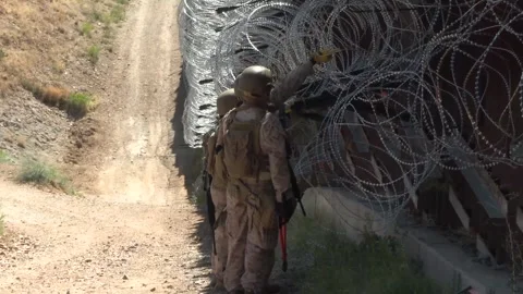 U.S. Marines conduct reinforcement work along the border wall  Stock Footage 334839013