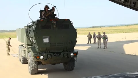 U.S. Marines driving HIMARS up ramp onto a U.S. Air Force C-17 Globemaster Stock Footage 284217742