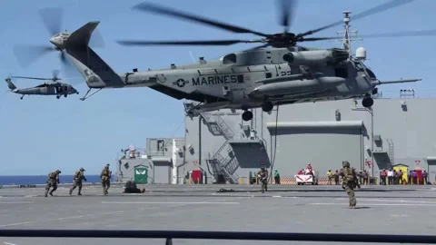 U.S Marines fastroping from CH-53 onto ship for Visit, Board, Search and Seizure Stock Footage 280748117