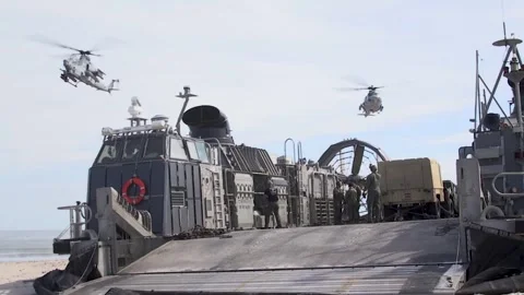 U.S. Marines helicopters hovering above LCAC during amphibious assault Stock Footage 278147970