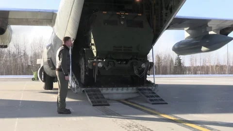 U.S. Marines HIMARS reversing into KC-130J Hercules aircraft Stock Footage 267073600
