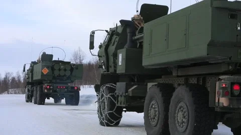 U.S. Marines HIMARS vehicles driving on snow covered ground in Norway Stock Footage 266402074