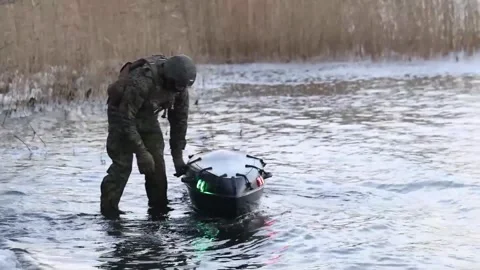 U.S. Marines launching 'Amy' small unmanned surface vessel in water Stock Footage 256637730