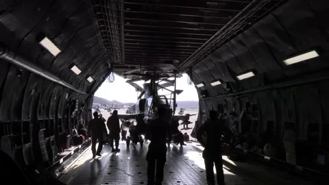 U.S. Marines loading AH-1Z Viper helicopter on to C-5 Galaxy aircraft Video stock 231861429
