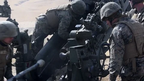 U.S. Marines loading and firing Howitzer during training Stock Footage 83579051