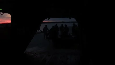 U.S Marines loading combat rubber raiding craft on to CH-47 Chinook at night Video stock 224489111