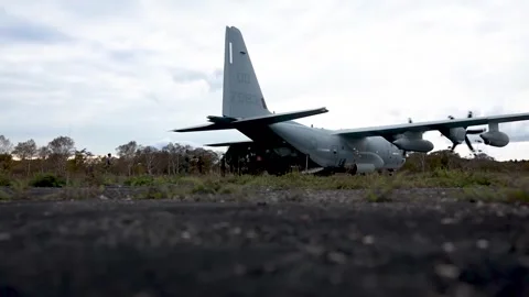 U.S. Marines off-loading HIMARS from C-130 Hercules during Resolute Dragon Stock Footage 254066249