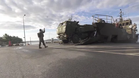 U.S. Marines loading M142 Himars onto Swedish Marines amphibious craft HMS Loke Video stock 278392335