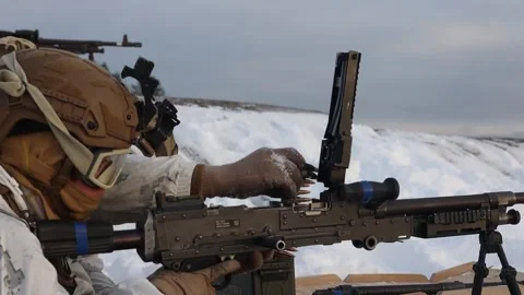 U.S. Marines loading M240B machine gun in snow covered landscape Video stock 263721203