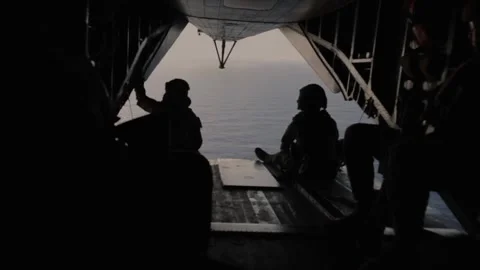 U.S. Marines looking out over water from rear ramp of CH-53 Super Stallion Stock Footage 265231356