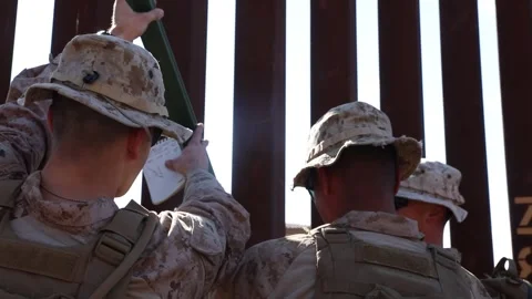 U.S. Marines measuring metal posts to attach to the Mexican border fence Stock Footage 300261081