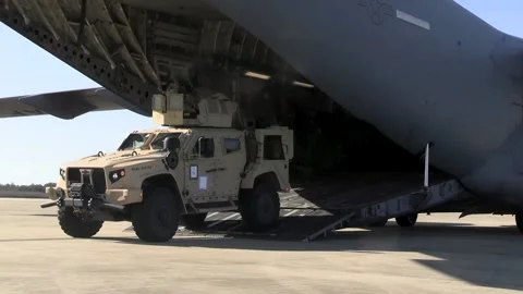 U.S. Marines Mine Resistant Ambush Protected Vehicle exiting a C-17 Globemaster Stock Footage 229618257