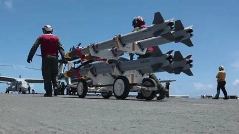U.S. Marines moving bomb rack on flight deck of USS America (LHA 6) Stock Footage 280748066