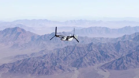 U.S. Marines MV-22 Osprey aircraft flying over mountain range Stock Footage 232393906