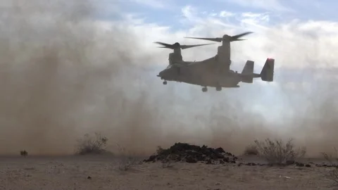 U.S. Marines MV-22 Osprey creates sandstorm in desert Stock Footage 257417757