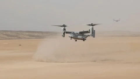 U.S. Marines MV-22 Osprey creates sandstorm during landing in desert  Stock Footage 257553075