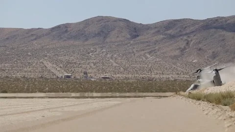 U.S. Marines MV-22 Osprey creating dust storm while taxiing in the desert Stock Footage 280034333