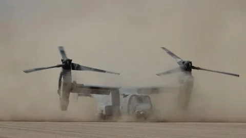 U.S. Marines MV-22 Osprey creating dust storm while ground-running in the desert Stock Footage 280034381