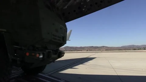 U.S. Marines offloading HIMARS from Royal Canadian C-17 Globemaster III aircraft Stock Footage 294751659