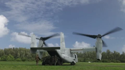 U.S. Marines offloading jeep from the rear of MV-22 Osprey Stock Footage 294680040