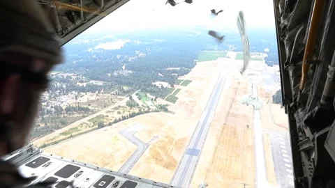 U.S. Marines parachute training over runway from KC-130 Super Hercules aircraft Stock Footage 282784464