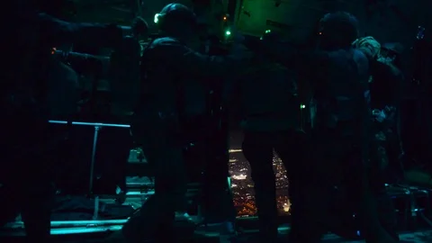 U.S. Marines perform static line jump from C-130 Hercules at night Stock Footage 102768856