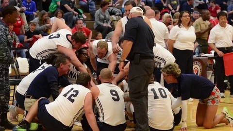 The U.S. Marines play the U.S. Navy in a game of seated volleyball. Stock Footage 74799228