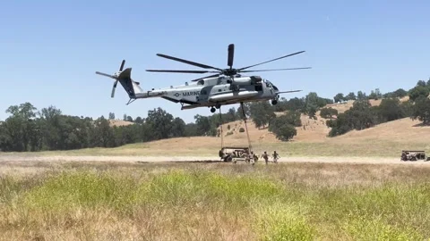 U.S. Marines running from CH-53 Super Stallion performing external lift Stock Footage 278581357