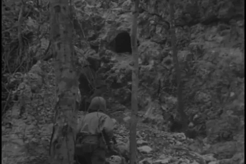 U.S. Marines throw bomb into cave - 1944 Stock Footage 93018881