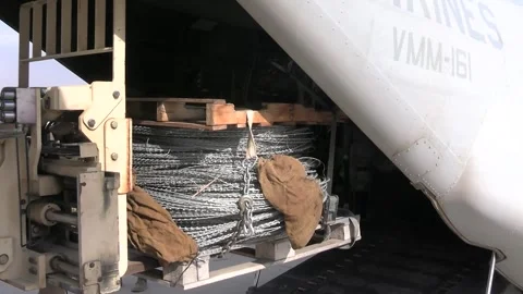 U.S. Marines unloading a pallet of razor wire from MV-22 Osprey for border wall Stock Footage 300261166