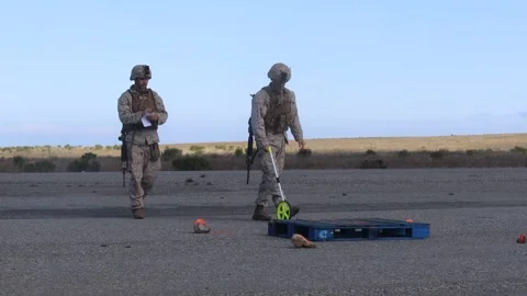 U.S. Marines using a measuring wheel to check distance on airfield Stock Footage 267958368
