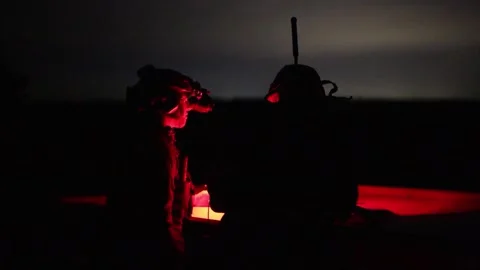 U.S. Marines utilizing infrared light from an observation tower at night Video stock 295620444