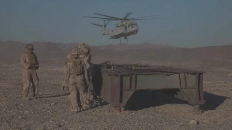 U.S. Marines waiting as CH-53K King Stallion arrives to perform heavy lift Stock Footage 253998033
