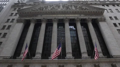 U.S. national flags wave at the New York Stock Exchange at the Wall Street Stock Footage 50522566
