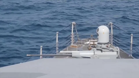 US Navy Combat Ship, Automatic Mark 38 gun Stock Footage 120967896