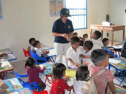 U.S. Navy Commodore Franchetti engages with preschool children at Otres Pri.. Stock Photos