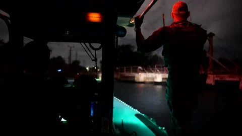 U.S. Navy EOD sailor standing on side of boat during rainfall Stock Footage 201074927