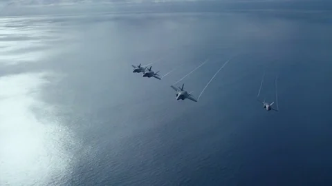 US Navy fighter jets fly over an aircraft carrier. Stock Footage 79416823
