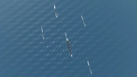 Us navy full carrier strike group from high altitude aerial open ocean blue Video stock 343839758