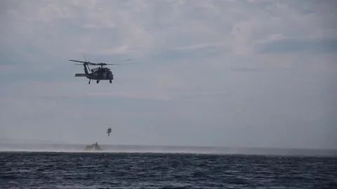 U.S. Navy MH-60 Seahawk recovering NASA astronauts during Orion recovery test Stock Footage 266248618