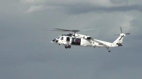 U.S. Navy MH-60 Seahawk with white paintwork hovering Stock Footage 275824163
