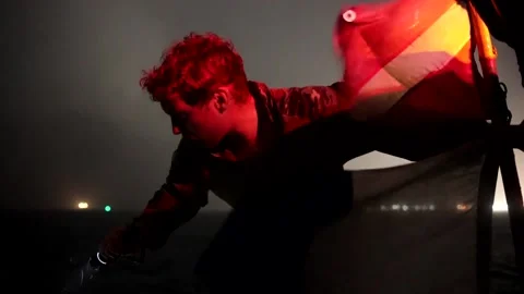 U.S. Navy sailor with EOD unit shining torch from boat at night Stock Footage 201074960