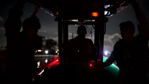 U.S. Navy sailor with explosive ordnance disposal unit navigating boat at night Stock Footage 201075002