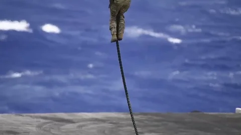 US Navy Sailor fast roping onto USS Theodore Roosevelt Stock Footage 81660376