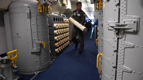U.S. Navy sailor loading sonobuoy sonar system into launcher oboard P-8 Poseidon Stock-Footage 110732277