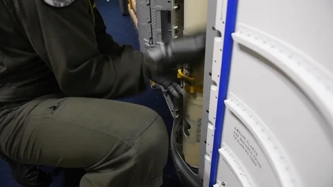 U.S. Navy sailor locking sonobuoy into position in launcher onboard P-8 Poseidon Vídeos de archivo 110732254